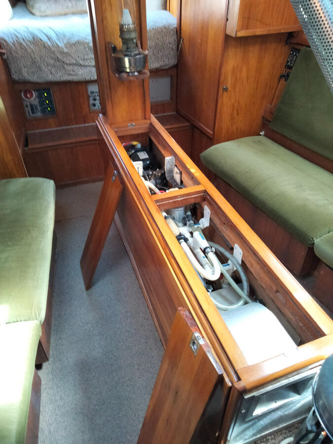 Refrigeration compresssors, plumbing manifolds and hot water calorifier within table spine