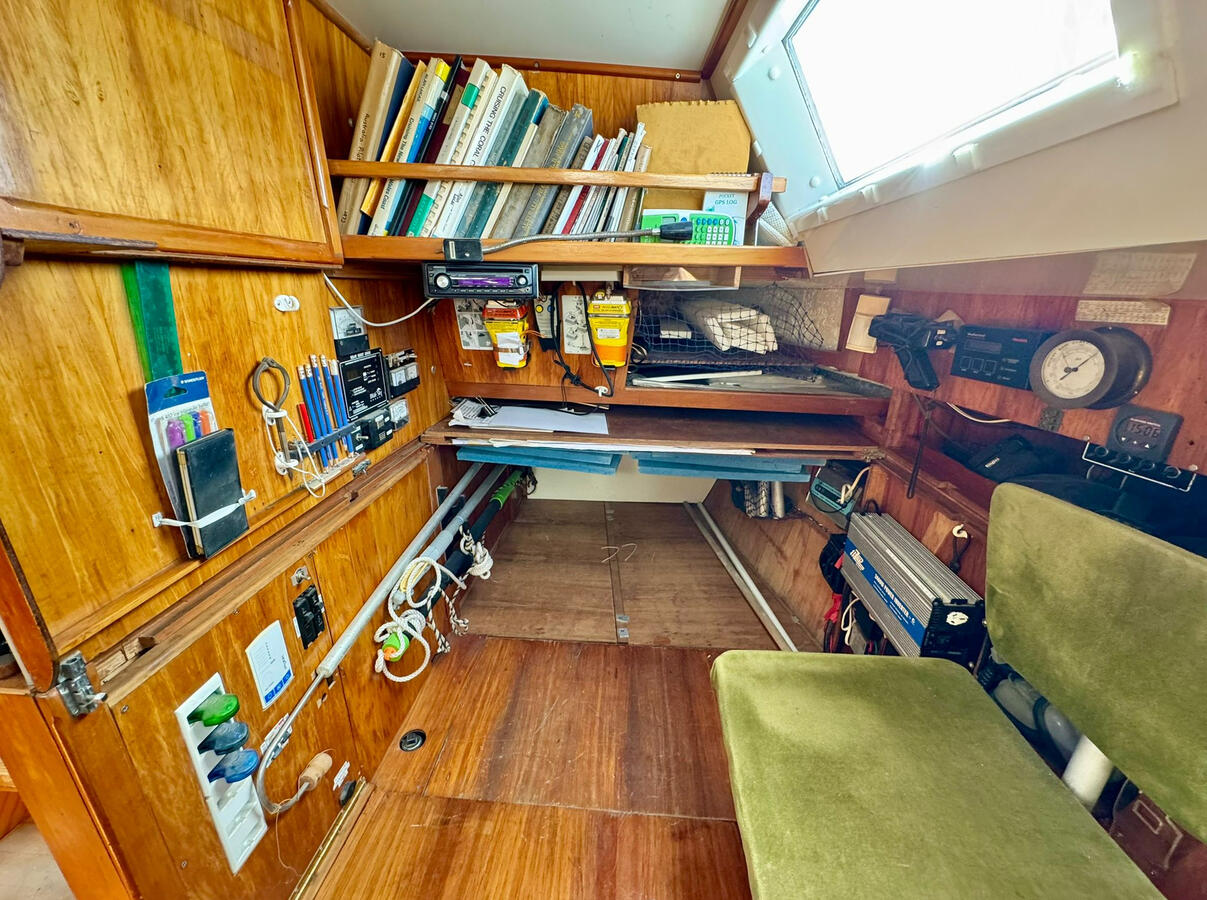 Nav area w chart table slid aft to access bunk area. Nav area w chart table slid aft to access bunk area.